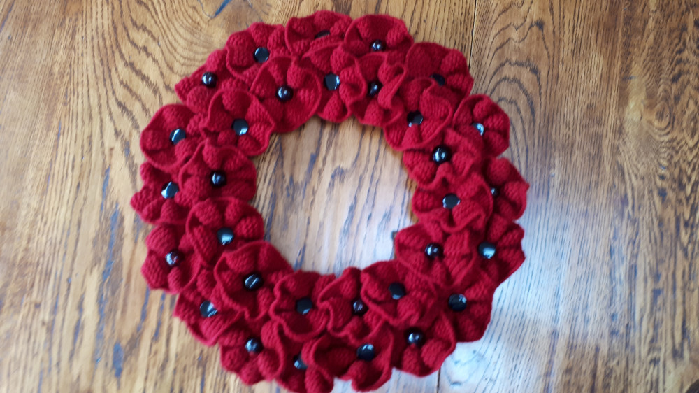 Handknitted poppy wreath